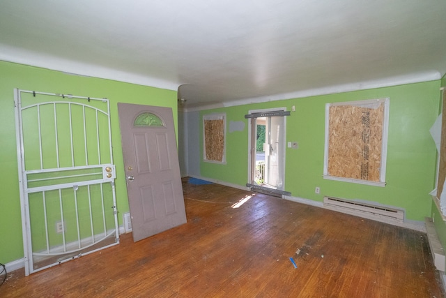 entryway with hardwood / wood-style floors and a baseboard heating unit