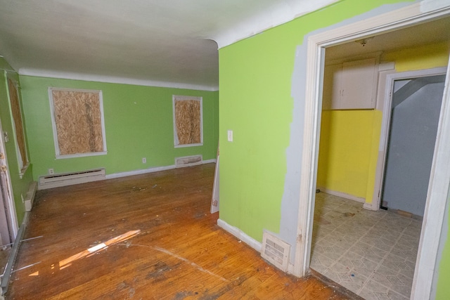 hall featuring hardwood / wood-style flooring and baseboard heating