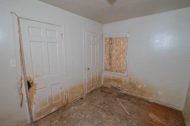 unfurnished bedroom featuring concrete floors