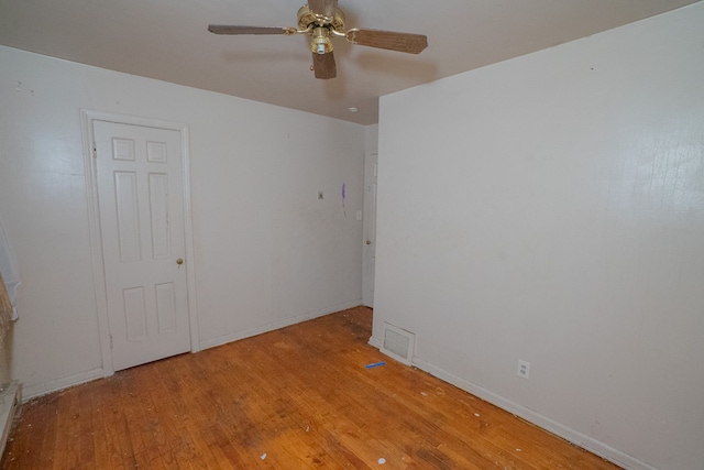 spare room featuring ceiling fan and light hardwood / wood-style flooring