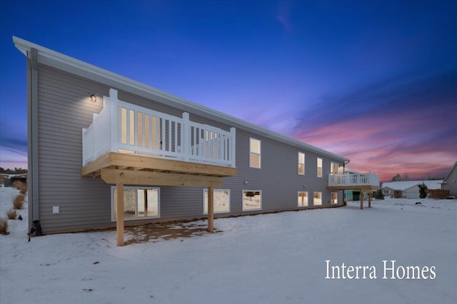 snow covered property featuring a deck