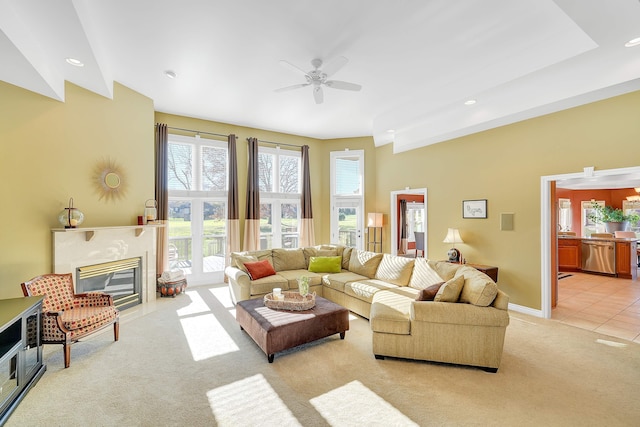 carpeted living room featuring ceiling fan