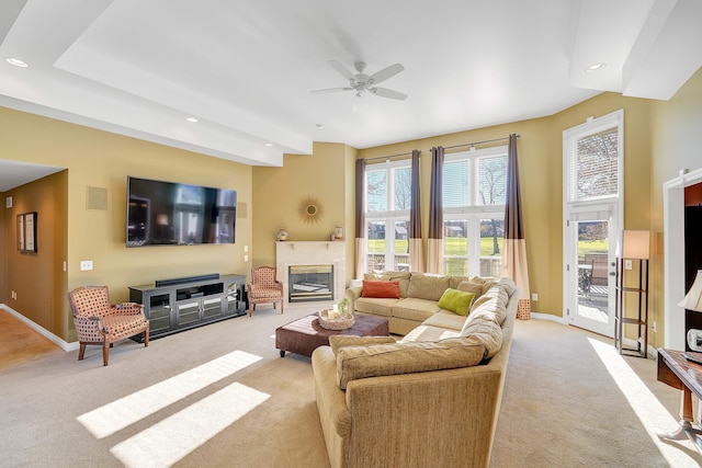 living room with ceiling fan and light colored carpet