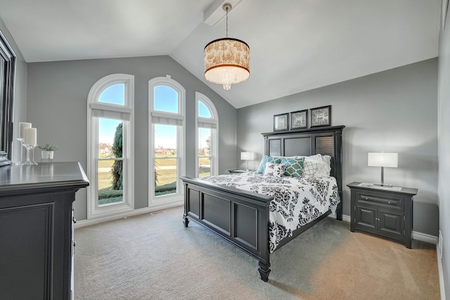 carpeted bedroom with vaulted ceiling