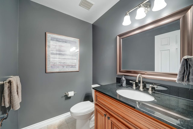 bathroom featuring tile patterned floors, vanity, and toilet