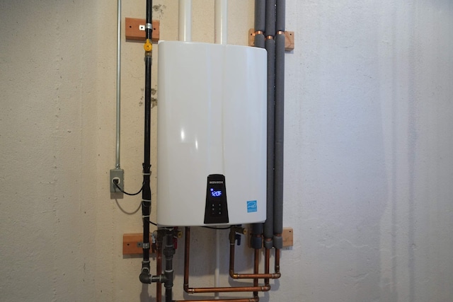 utility room with tankless water heater