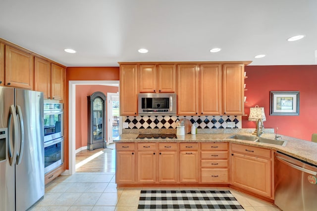 kitchen with decorative backsplash, appliances with stainless steel finishes, light tile patterned floors, and sink