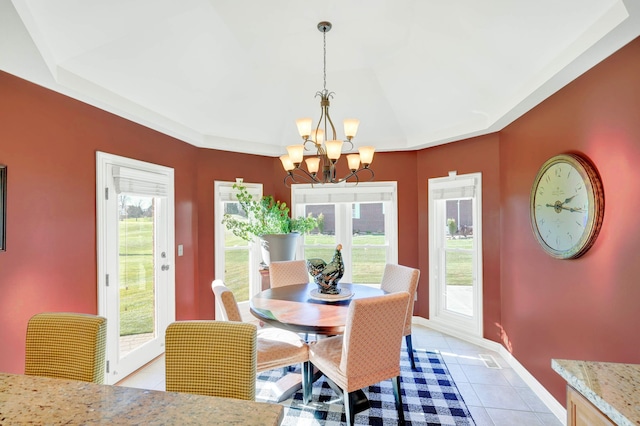 tiled dining area featuring plenty of natural light and a notable chandelier