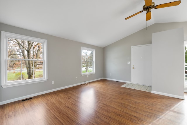 spare room featuring ceiling fan, lofted ceiling, and hardwood / wood-style flooring