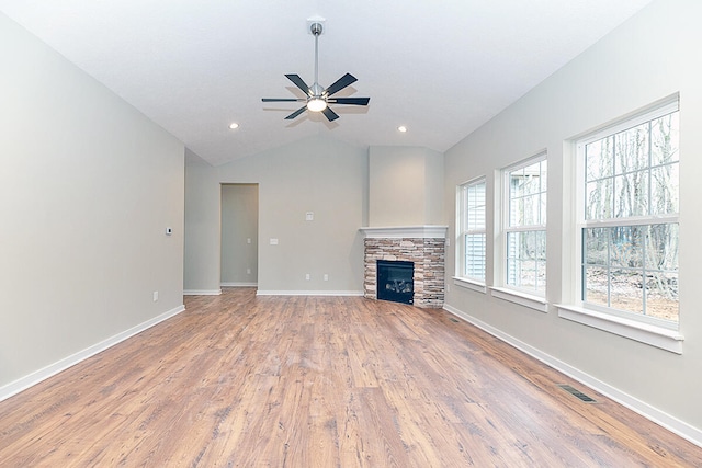 unfurnished living room featuring ceiling fan, wood-type flooring, a fireplace, and vaulted ceiling