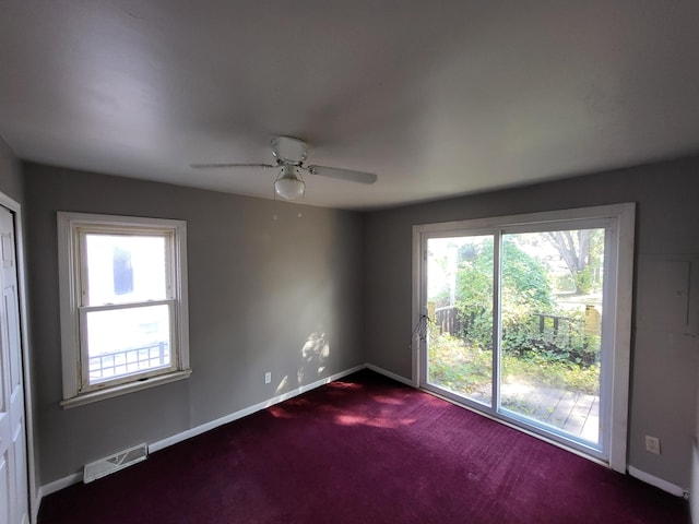 empty room featuring carpet flooring and ceiling fan