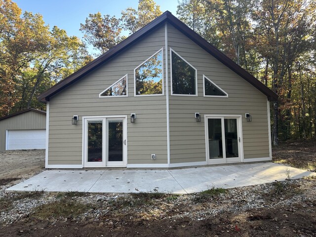 1820 S Reid Rd, Custer, MI 49405 - back of property with an outdoor structure, a patio area, and a garage