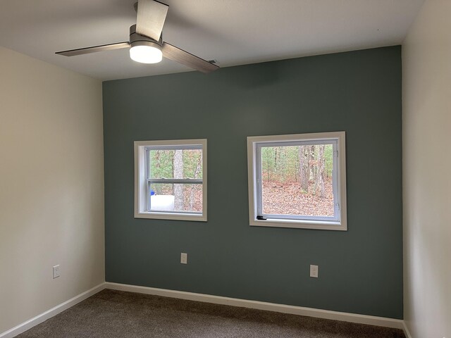 1820 S Reid Rd, Custer, MI 49405 - unfurnished room with dark carpet, ceiling fan, and baseboards