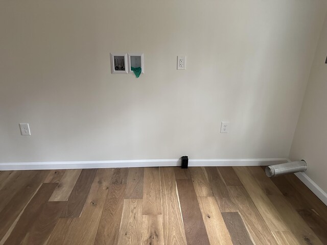 1820 S Reid Rd, Custer, MI 49405 - laundry area with hookup for a washing machine, baseboards, and wood finished floors