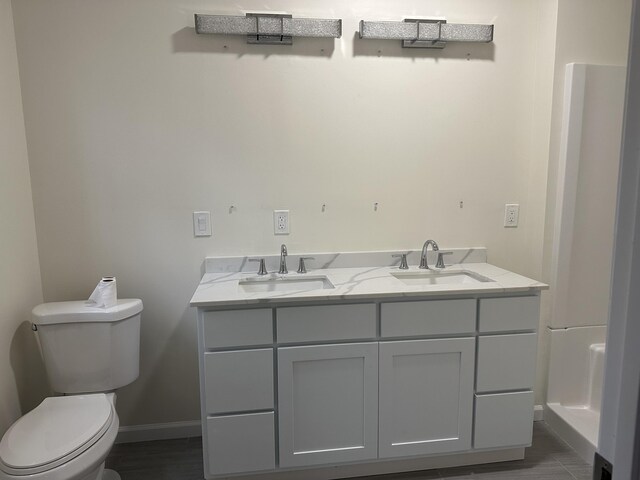 1820 S Reid Rd, Custer, MI 49405 - bathroom with toilet, baseboards, and double vanity