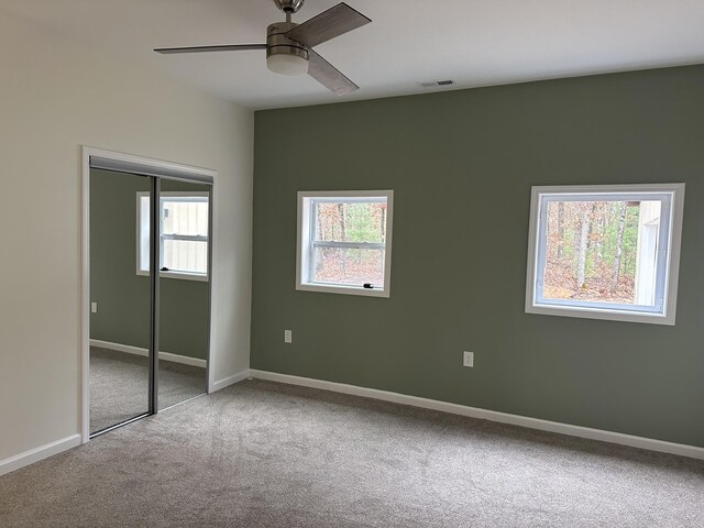1820 S Reid Rd, Custer, MI 49405 - unfurnished bedroom with carpet flooring, a closet, baseboards, and a ceiling fan