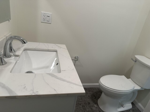 1820 S Reid Rd, Custer, MI 49405 - half bathroom with vanity, toilet, and baseboards