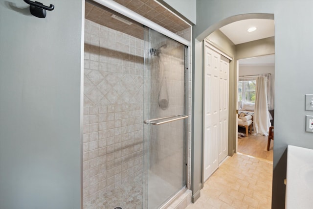 bathroom with hardwood / wood-style floors and a shower with door