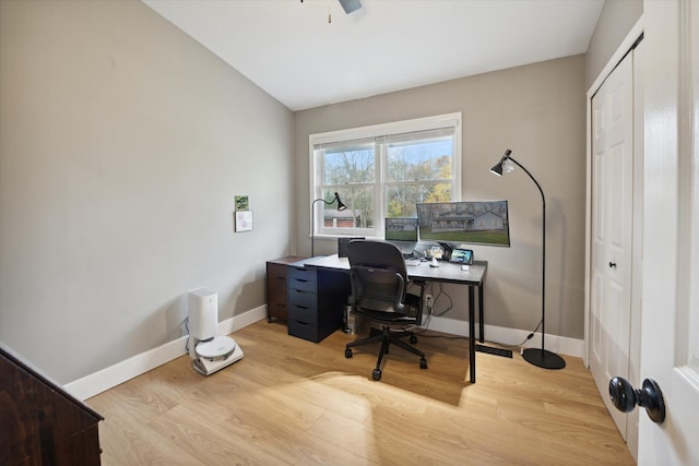 office area with light hardwood / wood-style floors and vaulted ceiling