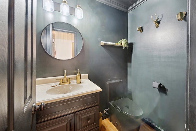 bathroom with wood-type flooring, vanity, toilet, and ornamental molding