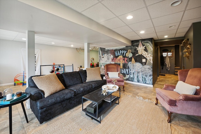 tiled living room featuring a paneled ceiling