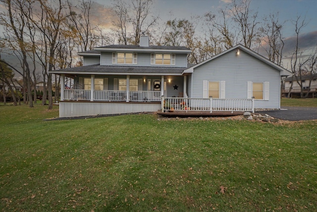 view of front of property with a lawn and a porch