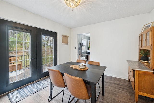 dining space featuring french doors, a textured ceiling, and dark hardwood / wood-style floors