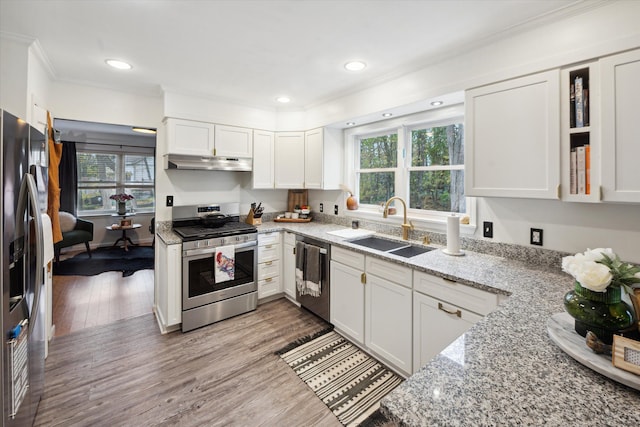 kitchen featuring white cabinets, light wood-type flooring, sink, and appliances with stainless steel finishes