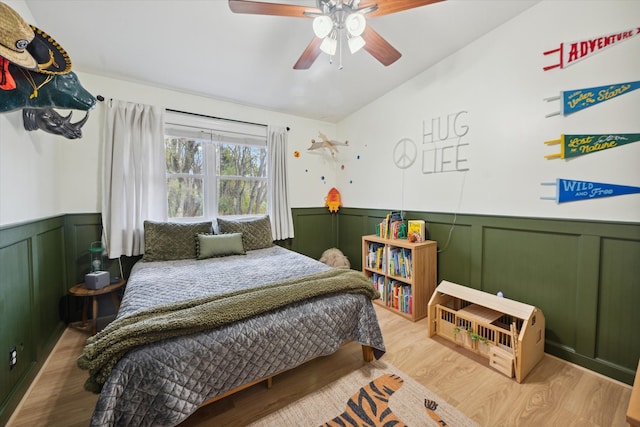 bedroom with ceiling fan, light wood-type flooring, and lofted ceiling