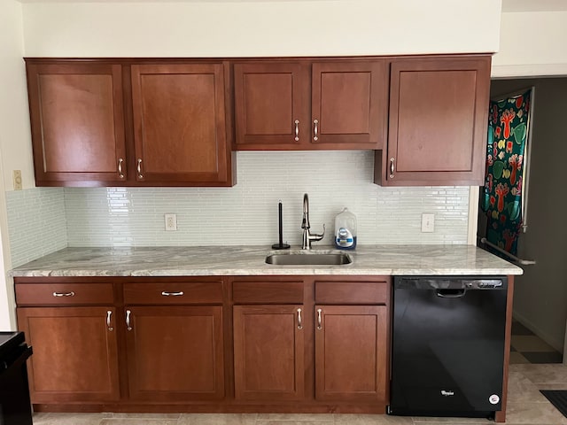 kitchen featuring backsplash, light stone countertops, sink, and black appliances