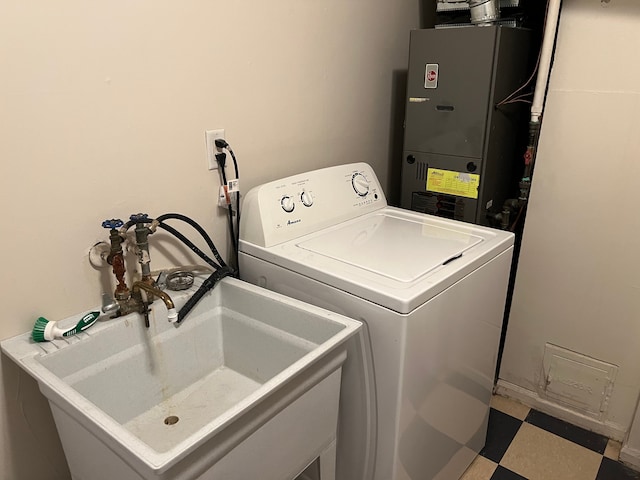 washroom featuring washer / clothes dryer, sink, and heating unit