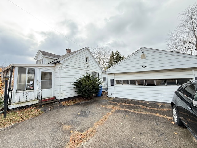 view of front of home featuring a sunroom