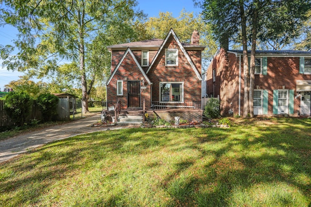 tudor home with a front yard