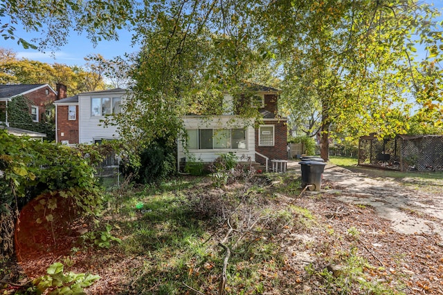 rear view of house with central AC unit