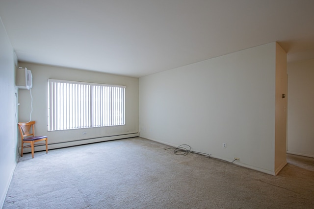 carpeted spare room featuring a wall mounted air conditioner and a baseboard radiator