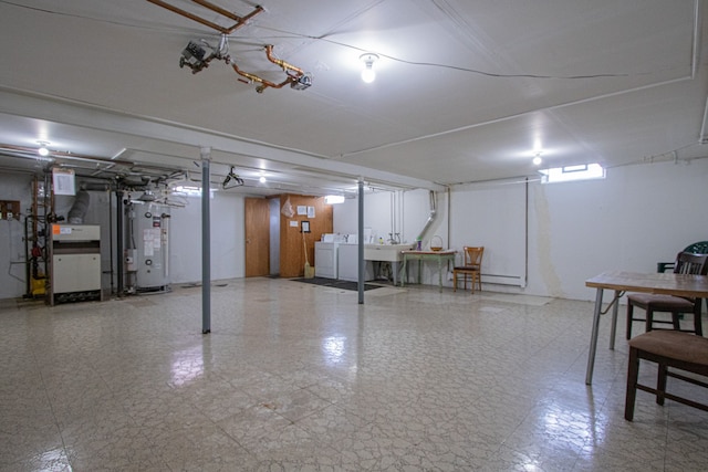 basement with water heater and washing machine and clothes dryer