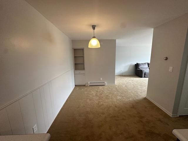 interior space featuring baseboards, a baseboard heating unit, and carpet