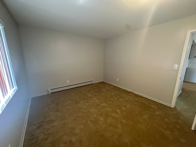 empty room featuring baseboards, a baseboard radiator, and carpet