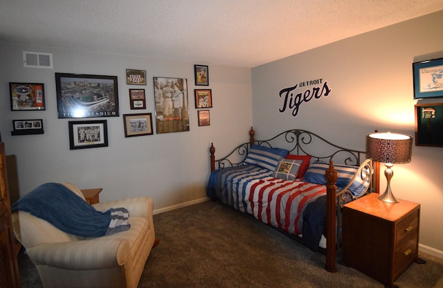 carpeted bedroom featuring a textured ceiling