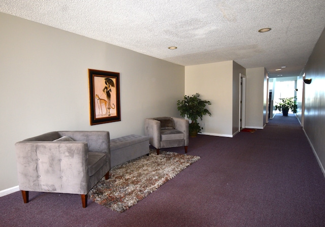 interior space with dark colored carpet and a textured ceiling