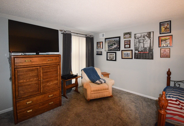 living area featuring dark carpet and a textured ceiling