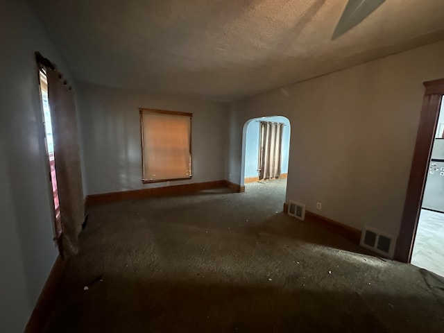 carpeted spare room featuring a textured ceiling