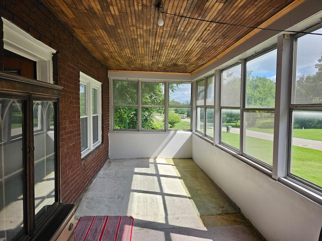 unfurnished sunroom with wooden ceiling and a healthy amount of sunlight