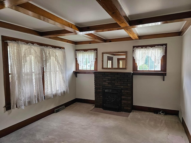 unfurnished living room with a brick fireplace, light colored carpet, beamed ceiling, and coffered ceiling