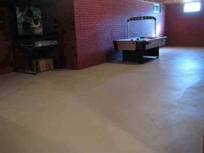 basement with pool table and brick wall