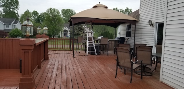 wooden deck with a gazebo and an outdoor bar