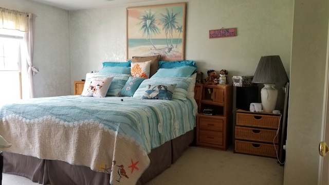 bedroom featuring light colored carpet