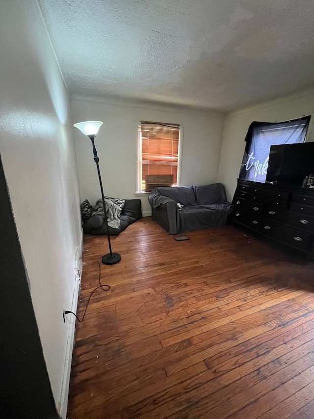 living room featuring dark hardwood / wood-style floors and a textured ceiling