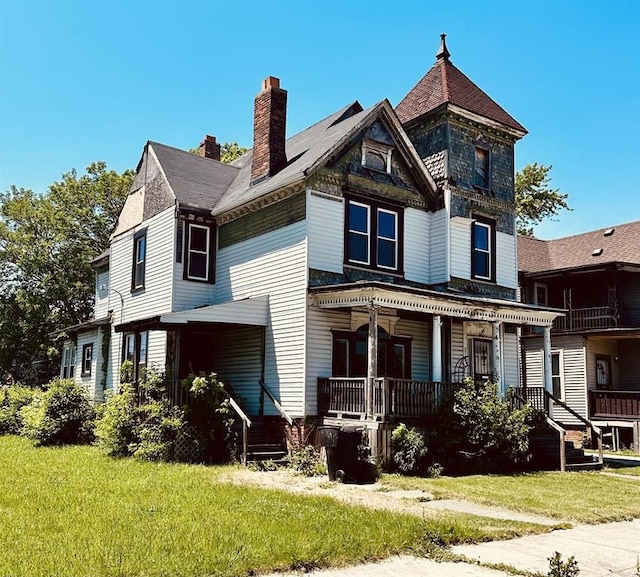 3715 14th St, Detroit, MI 48208 - victorian home with a porch, a front lawn, and a chimney
