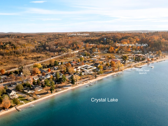 drone / aerial view with a water view and a beach view